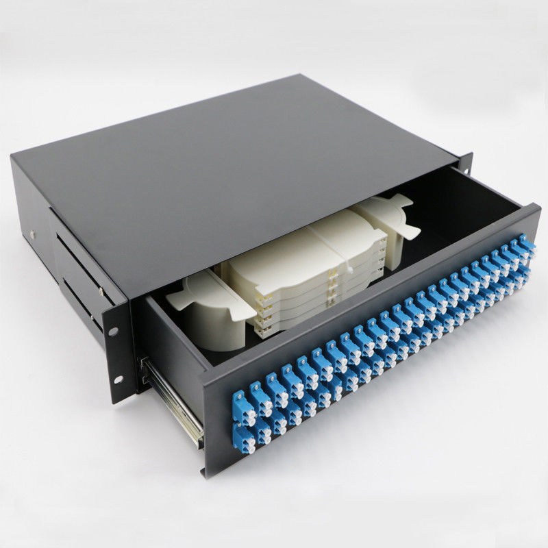 Desktop fiber terminal box open showing internal splice tray